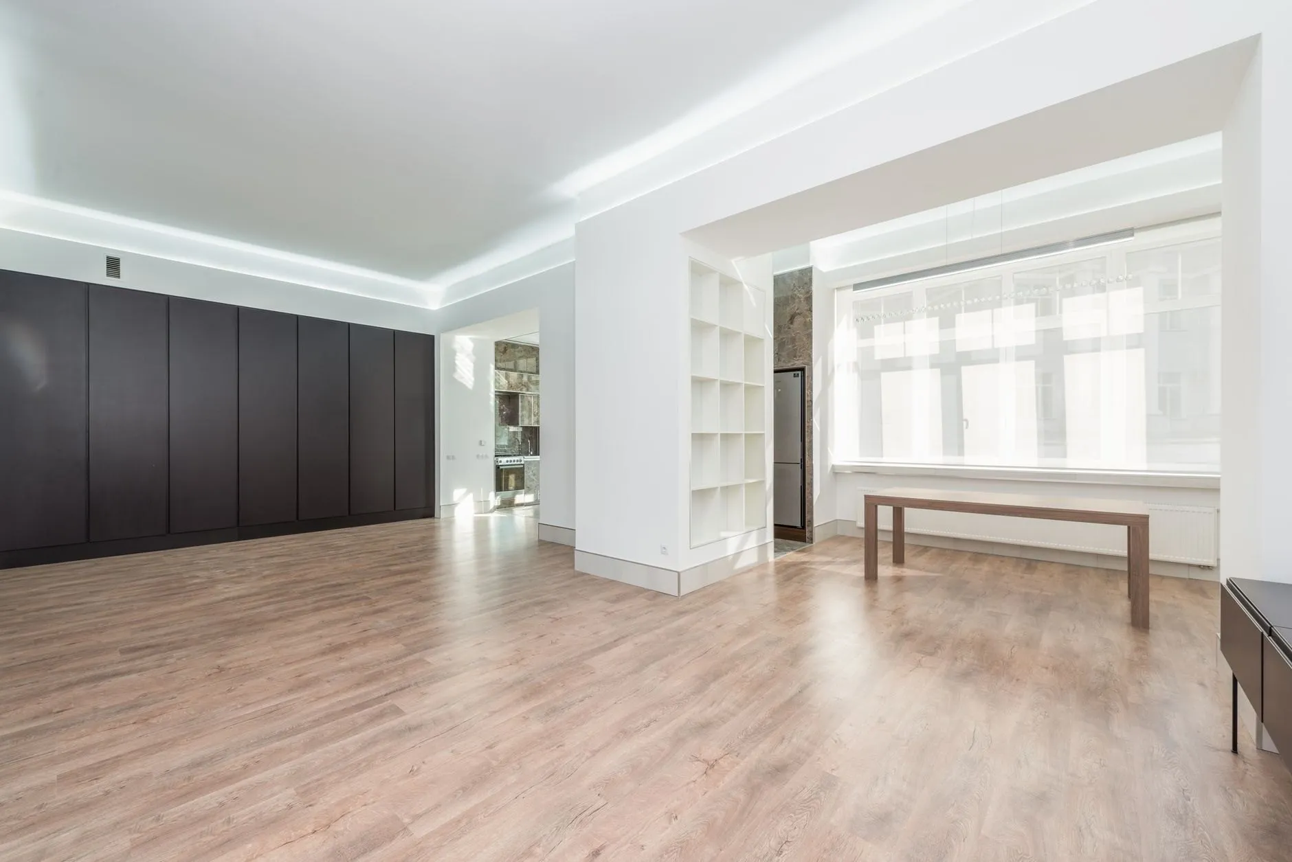 Through lounge with pale oak floor and a wide window